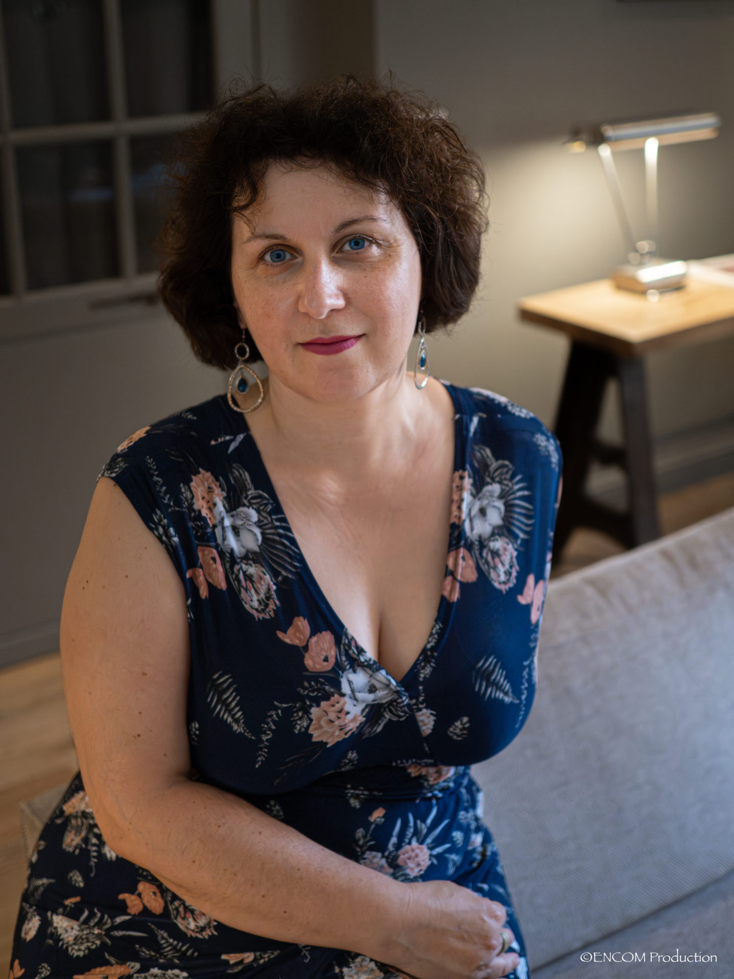 Claire assise en robe bleue avec des fleurs